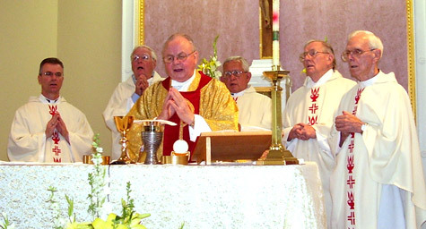 Father Raymond Rossi celebrates Mass at St. Joseph Church in Center Ridge June 1. Also at the altar is Father T.J. Hart, Msgr. John O'Donnell, Msgr. Hebert, Father Joseph Enderlin and Father Yates.