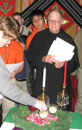Father Hugh Assenmacher, OSB, Subiaco Academy's chaplain, blesses the Advent wreath during a service in December 2007 in the foyer of the Performing Arts Center.