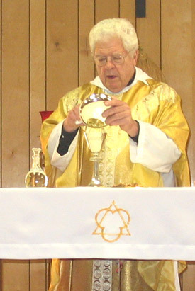 Father Thomas Keller celebrates Mass at Holy Trinity Church in England in December 2007. He recently marked 50 years as a priest.