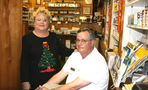 Becky and Randy Shinabery take time out from their work day at Shinny's Nyal Drug Store to talk about St. Norbert Church in Marked Tree Dec. 15. They live next to the church on Normandy Street.