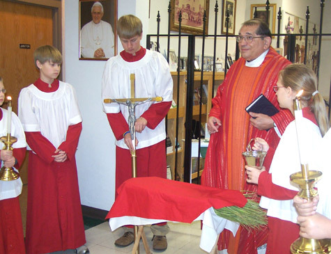 Msgr. James Mancini prepares to bless the palms at the morning Mass at St. Joseph Church in Tontitown on Palm Sunday in 2008.