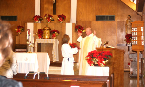 Father Phillip Reaves celebrates Mass at St. Mary Church in McGehee Jan. 9 while Father Chuma P. Ibebuike, administrator, is on vacation. Parishioners gather before each Mass for the rosary.