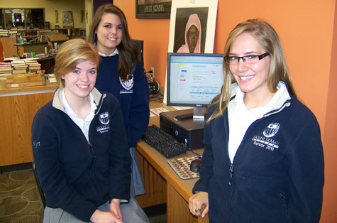 Mount St. Mary senior leaders check the latest fundraising totals from GoodSearch. They are Joslyn Hebda (from left), Christa Campo and Caroline Kirby.