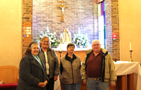 Beverly McDonald (left), Mary Hale and Beverly and Jim Searvogel look toward the future for their growing parish, Holy Cross in Sheridan.