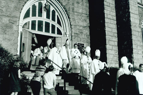 Newly-ordained auxiliary bishop for the Diocese of Little Rock, Lawrence P. Graves, walks down the steps of the Cathedral of St. Andrew in Little Rock April 25, 1969, with others who attended the ordination.