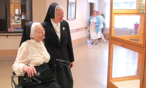 Benedictine Sisters Corinne Lange (left) and Delores Vincent Bauer share a moment of bird-watching in St. Scholastica Infirmary May 3.