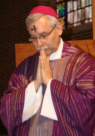 Bishop Anthony B. Taylor prays during an Ash Wednesday service for diocesan employees in 2012.