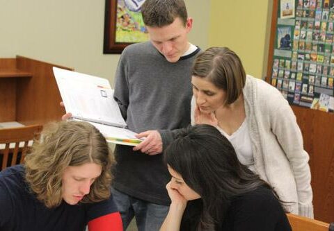 During a recent Natural Family Planning class, NFP instructors Jason and Erin Pohlmeier check the charting calculations of class participants Koty Ruth and Cristina Pena of St. Theresa Church in Little Rock.