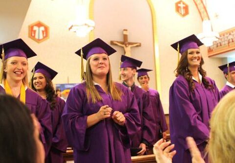 Members of the Class of 2013 are applauded after they receive their diplomas from St. Joseph High School in Conway May 12. Twelve seniors who maintained a 3.5 grade point average throughout high school and fulfilled other requirements graduated with honors.