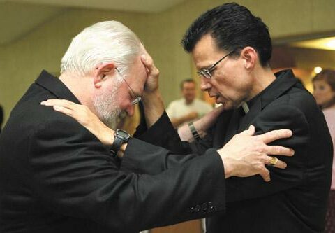 Deacon Rick Hobbs (right) blesses seminarian Jack Sidler Sr. May 31 after his diaconate ordination Mass in Fort Smith. Both men attend Sacred Heart School of Theology in Wisconsin.
