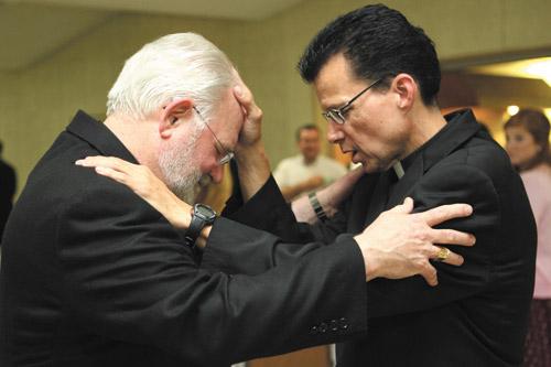 Deacon Rick Hobbs (right) blesses seminarian Jack Sidler Sr. May 31 after his diaconate ordination Mass in Fort Smith. Both men attend Sacred Heart School of Theology in Wisconsin.