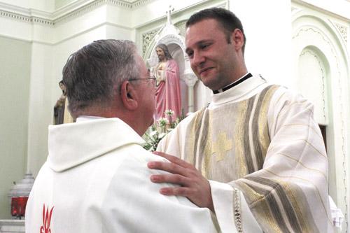 Deacon Robert Cigainero is congratulated by one of the many deacons, priests and seminarians who attended his ordination Mass at St. Edward Church in Texarkana May 25.