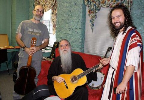 Kent Butler (right), The Great Passion Play assistant executive director and a cast member, checks in  with musicians Michael Card (left) and John Michael Talbot before they perform in Eureka Springs Aug. 6.