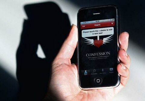 A woman holds an iPhone with a confession application. A Vatican official said the app can help Catholics prepare for confession, as its developers in-tended, but that it cannot substitute for the sacramental encounter between a penitent and a priest.