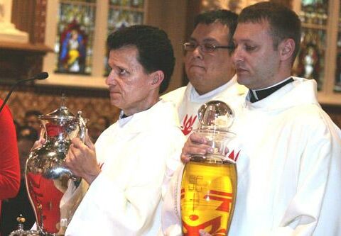 Deacons Rick Hobbs (left), Juan Guido and Robert Cigainero present the chrism oil to Bishop Anthony B. Taylor during the annual Chrism Mass at the Cathedral of St. Andrew in Little Rock April 14. All three men are scheduled to be ordained to the priesthood at 10 a.m. Saturday, May 17 at Christ the King Church in Little Rock.