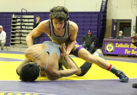 Connor Perkins, Catholic High School senior, gets the upper hand on his Central High opponent during the 115-pound match of an exhibition wrestling meet Jan. 7 in Little Rock.