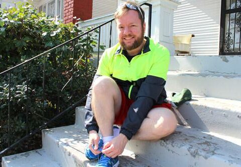 Father Jason Tyler, pastor of St. Edward Church in Little Rock, laces up on the steps of the rectory before a training run. Father Tyler trained for six months to prepare for the March 1 Little Rock Marathon.
