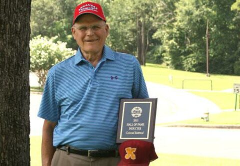 Conrad Battreal, a member of Christ the King Church in Little Rock, stands with his Arkansas Slow-Pitch Softball Hall of Fame inductee plaque and his Christ the King ball cap at St. John Center July 9.