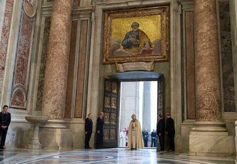 Pope Francis prays at the Holy Door of St. Peter's Basilica after opening it to inaugurate the Jubilee Year of Mercy at the Vatican Dec. 8.