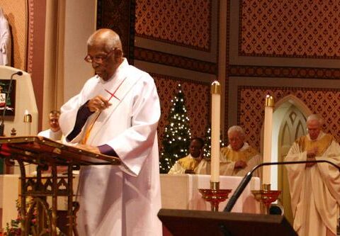 Deacon Kirke Herman reads the Gospel during the Martin Luther King Jr. Mass at the Cathedral of St. Andrew in Little Rock in January 2015. Herman, one of the first two black permanent deacons ordained in the Diocese of Little Rock, died Oct. 18, 2015, at age 87.