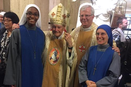 Sister Kibeho, (left) a 22-year-old from Christ the King Church in Little Rock, is a novice with the Servants of the Lord & Virgin of Matara in Maryland. On Dec. 7, she received her habit during an investiture ceremony in Washington, D.C. Also pictured from left: Cardinal Theodore McCarrick, archbishop emeritus of Washington, D.C.; Msgr. Francis Malone, pastor of Christ the King Church; and Mother Mary of the Sacred Heart Gaes, provincial superior.