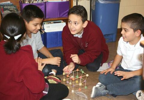 Teams of St. Theresa students in Little Rock try to build the tallest tower using only toothpicks and gumdrops. Pictured are Marley Moreno, second grade (left); Antonio Ramos, fourth grade; Tristan Soto, fourth grade; and Juan Gutierrez, second grade.