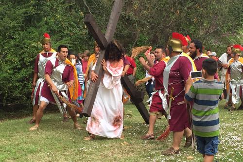 Jesus, played by Leonel Ramirez, carries his cross on Good Friday 2015 in live Stations of the Cross at Our Lady of Fatima Church in Benton. Playing Roman guards are David Linares (left), Juan Luis Ramirez, Efrain Huerta, Efrain Mendoza and Ilarion Atilano.