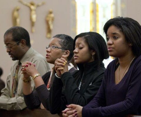 A family prays after arriving for Sunday Mass in 2011 at St. Joseph's Catholic Church in Alexandria, Va. Pope Francis' postsynodal apostolic exhortation on the family, "Amoris Laetitia" ("The Joy of Love"), was to be released April 8. The exhortation is the concluding document of the 2014 and 2015 synods of bishops on the family.