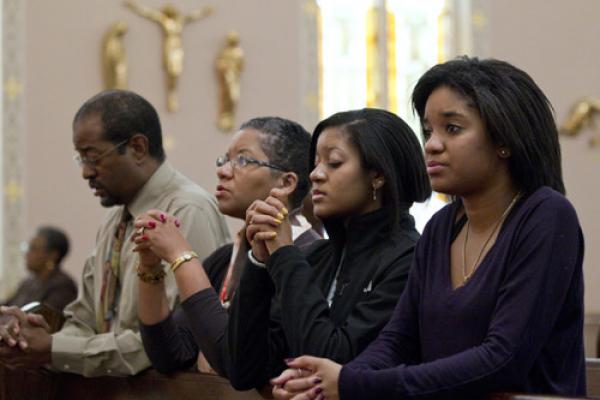 A family prays after arriving for Sunday Mass in 2011 at St. Joseph's Catholic Church in Alexandria, Va. Pope Francis' postsynodal apostolic exhortation on the family, "Amoris Laetitia" ("The Joy of Love"), was to be released April 8. The exhortation is the concluding document of the 2014 and 2015 synods of bishops on the family.