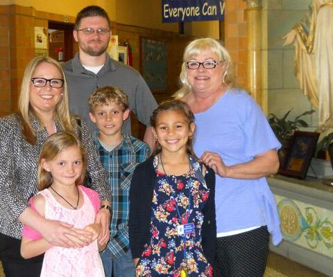 Second-grader Isabella Kindrick (front row right), who was selected as Principal for the Day at Immaculate Conception School, assists Sharon Blentlinger (back row right) with a school tour for a visiting family from Kentucky.