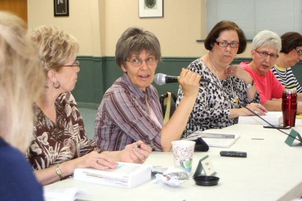 Debbie McCollough (with microphone) answers a question during her catechism adult faith formation class May 10 at St. Anne Church in North Little Rock. Others pictured are Fran Cook (left), June Parsley, Ramona Bourdo and Jean Zehler, all parishioners at Immaculate Conception Church in North Little Rock.