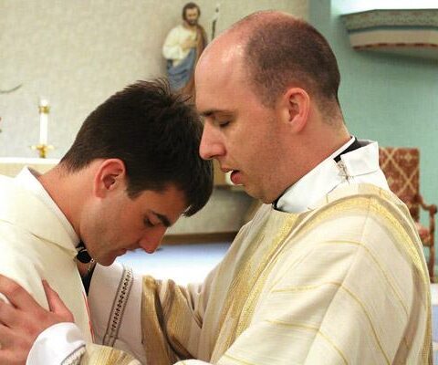 At the conclusion of his Mass of Ordination at St. Joseph Church in Conway June 2, Deacon William Burmester (right) blesses Deacon Mike Johns, who became a transitional deacon May 24 in Jonesboro.