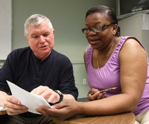 John Lundy, a member of the Ignatian Volunteer Corps, works one-on-one with Berta Alvarez, an immigrant from Honduras, while leading a class in English as a second language June 2, 2014, at Mercy Center in New York.