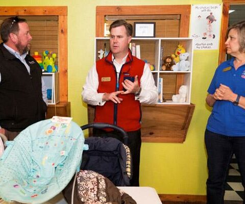 Justin White (center) talks with board member Dustin Stringer and employee Deb Upp during a visit to the First Choice Pregnancy Center in Texarkana in February 2016.