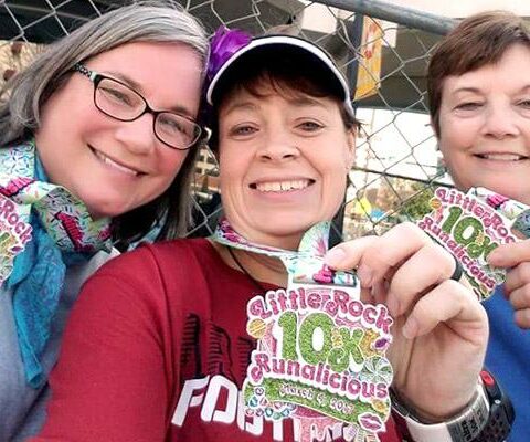 St. Theresa School coach Melanie Meuse-Warg (left), second-grade teacher Amanda Williams and librarian Karen Stoltz pose with their medals after the 10K race of the Little Rock Marathon March 4.