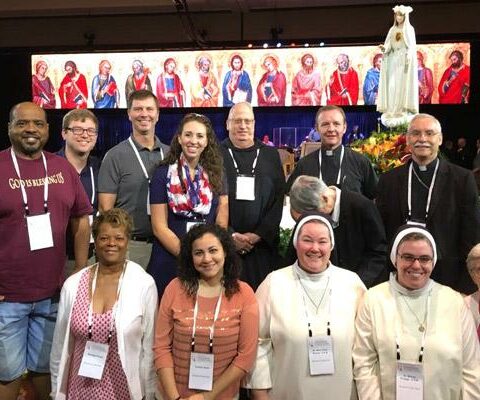 Thirteen Catholics represent the Diocese of Little Rock during the Convocation of Catholic Leaders July 1-4 in Orlando. Joining Bishop Anthony B. Taylor (right) were Tim Pruitt (back row, from left), Adam Koehler, Matt Tucker, Samantha Denefe, Brother Anthony Pierce, Father Erik Pohlmeier; Rosalyn Pruitt (front row, from left), Cynthia Solis, Sister Mary Clare Bezner, OSB, Sister Glorea Knaggs, OSB, and Sister Rosalie Ruesewald. Sister Ethel Marie Sonnier also attended, but is not visible.