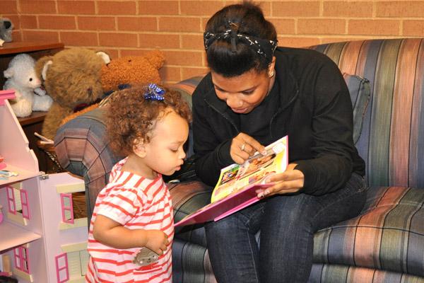 Alex reads to Olivia, then 16 months old, from a book created by her adoptive parents Rebecca and Michael that tells the story of her adoption. Alex, Olivia&#039;s birth mother, visits with the family at least once a year. 