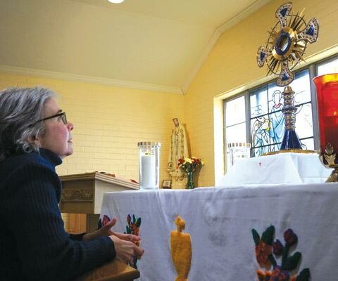 Jo Ann Gourley prays in the perpetual Eucharistic adoration chapel at Our Lady of Fatima in Benton. Signing up for a holy hour can be a powerful way to develop a closer relationship with Jesus during Lent.