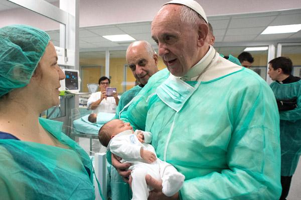 Pope Francis holds a baby as he visits the neonatal unit at San Giovanni Hospital in Rome in this Sept. 16, 2016, file photo. The visit was part of the pope&#039;s Friday works of mercy. (CNS photo/L&#039;Osservatore Romano)
