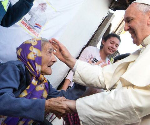 Pope Francis greets an elderly woman as he meets with people of the Banado Norte neighborhood in Asuncion, Paraguay, in this July 12, 2015, file photo. The pope has shown special concern for the aged, the sick and people with disabilities.