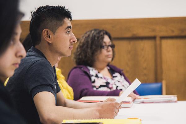 Jos&eacute; R. Salazar and Reina Rodr&iacute;guez (back, right) listen during an RCIA class in Springdale March 18. Dozens of Latinos are moving from &ldquo;cultural&rdquo; Catholicism to receiving their sacraments this Easter. (Travis McAfee photo)