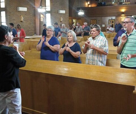 Nancy Quinn, a deaf interpreter during the 10 a.m. Sunday Mass at St. Mary Church in North Little Rock, and members of the deaf community sign the prayers July 8.