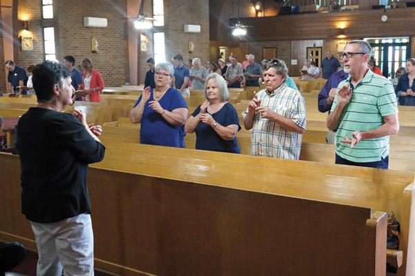 Nancy Quinn, a deaf interpreter during the 10 a.m. Sunday Mass at St. Mary Church in North Little Rock, and members of the deaf community sign the prayers July 8.