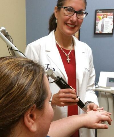 Dr. Sandra Johnson demonstrates a laser treatment on Kimberly Jarsma, a surgical nurse at Johnson Dermatology Clinic in Fort Smith, Oct. 1.