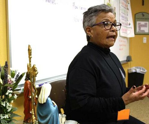 Juanita Lamb, parishioner of St. Raphael Parish in Springdale, speaks to students at Ozark Catholic Academy Dec. 5 about the imagery and symbolism represented in the image of Our Lady of Guadalupe to St. Juan Diego.