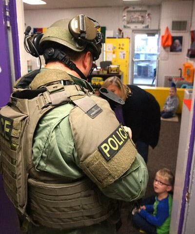 A Conway police SWAT officer looks at a student on the floor while checking elementary rooms at St. Joseph School in Conway. The Nov. 5 training al-lowed the SWAT team, teachers and students a chance to assess their intruder emergency plans.