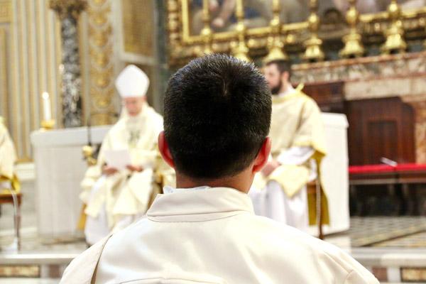 Father Mart&iacute;n Amaro stands before Bishop Anthony B. Taylor during his ordination Mass May 11 in St. Peter Basilica at the Vatican. Father Amaro attended the North American College in Rome for the past four years and chose to be ordained in Italy. (Denis Nakkeeran photo, Pontifical North American College)