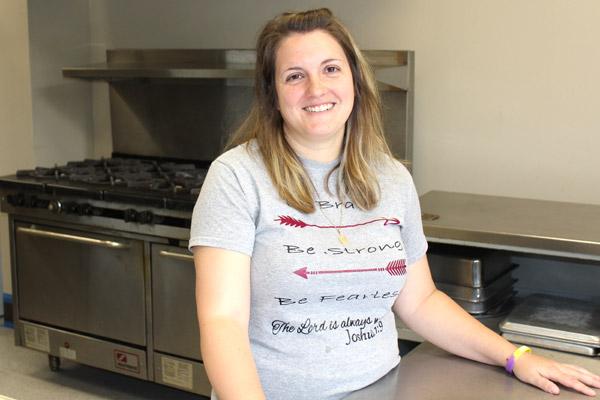 Principal Kristy Dunn takes a breather in the St. Theresa School kitchen. The Little Rock school landed a grant that will provide free hot breakfast for students and subsidize after-school care.