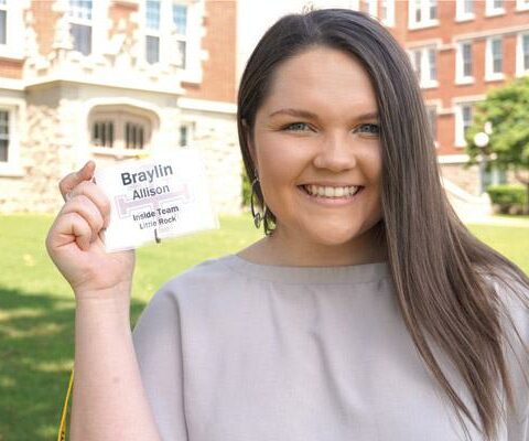 At St. John Center in Little Rock, Braylin Allison, 23, holds up her ID badge from a diocesan Search retreat, where she serves as an adult leader. She attends Christ the King Church in Little Rock.