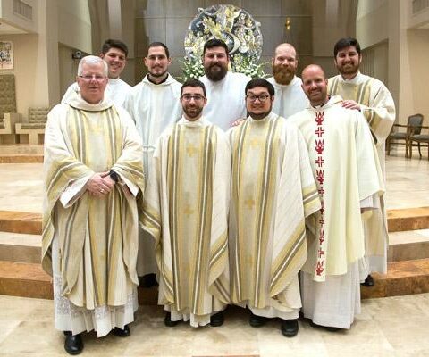 Bishop-elect Francis I. Malone stands with new priests and seminarians from his parish in 2018. They are Fathers Joseph de Orbegozo (front row, from left), Stephen Elser and Patrick Friend, seminarians Daniel Wendel (back row, from left), Ben Riley, Brian Cundall, Joseph Friend and then-Deacon (now Father) Jon Miskin.